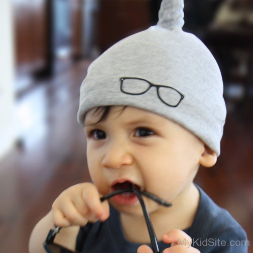 Cute Baby Holding Glasses