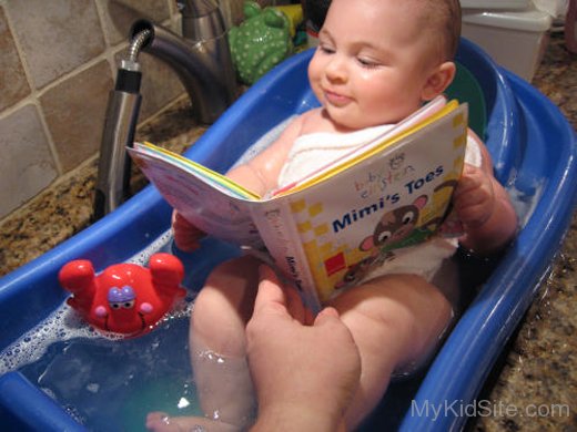 Cute Baby Reading In Bathtub Seat