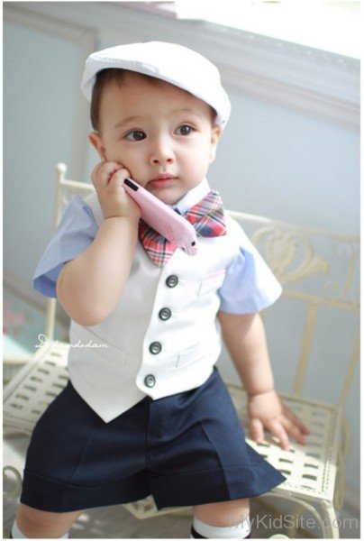 Stylish Baby Boy With Pink Mobile